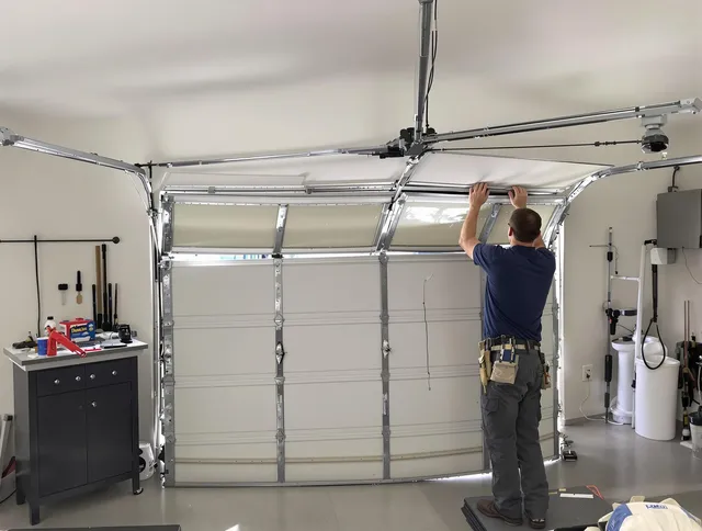 Groton Garage Door Repair specialist performing precise section replacement on Groton garage door